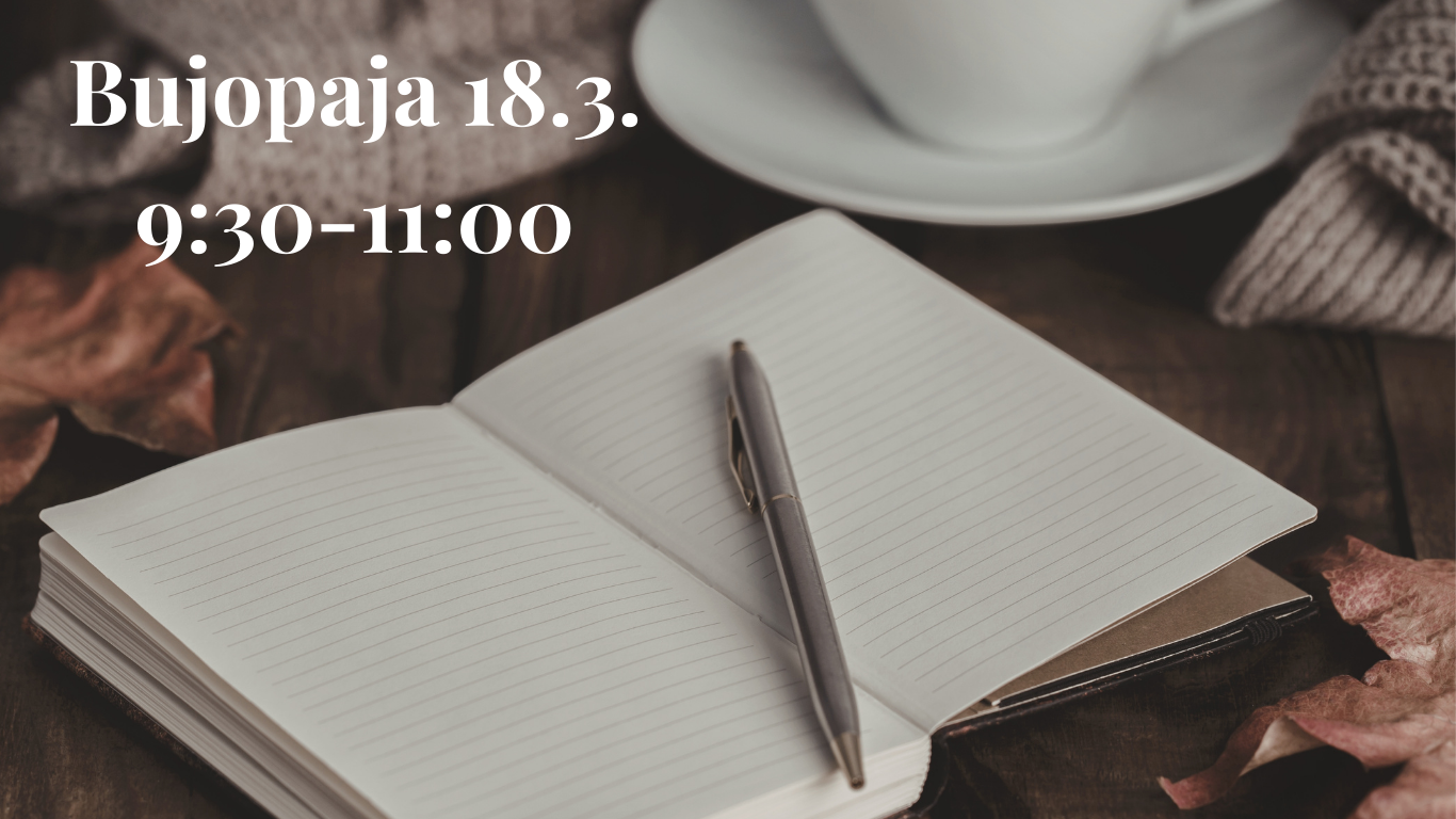 Vihko jonka päällä on kynä, taustalla valkoinen teekuppi.